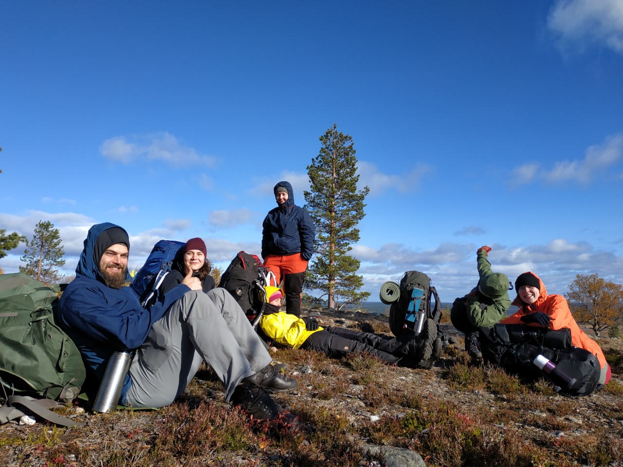 A group of hikers sitting together on a calm day