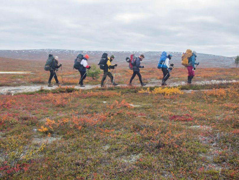 Six people hiking in the northern wilderness.